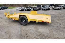 Equipment trailer rental Indianapolis – utility trailer hauling a skid steer across the metro.