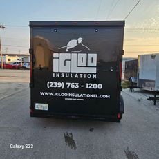 A black trailer with igloo insulation written on it