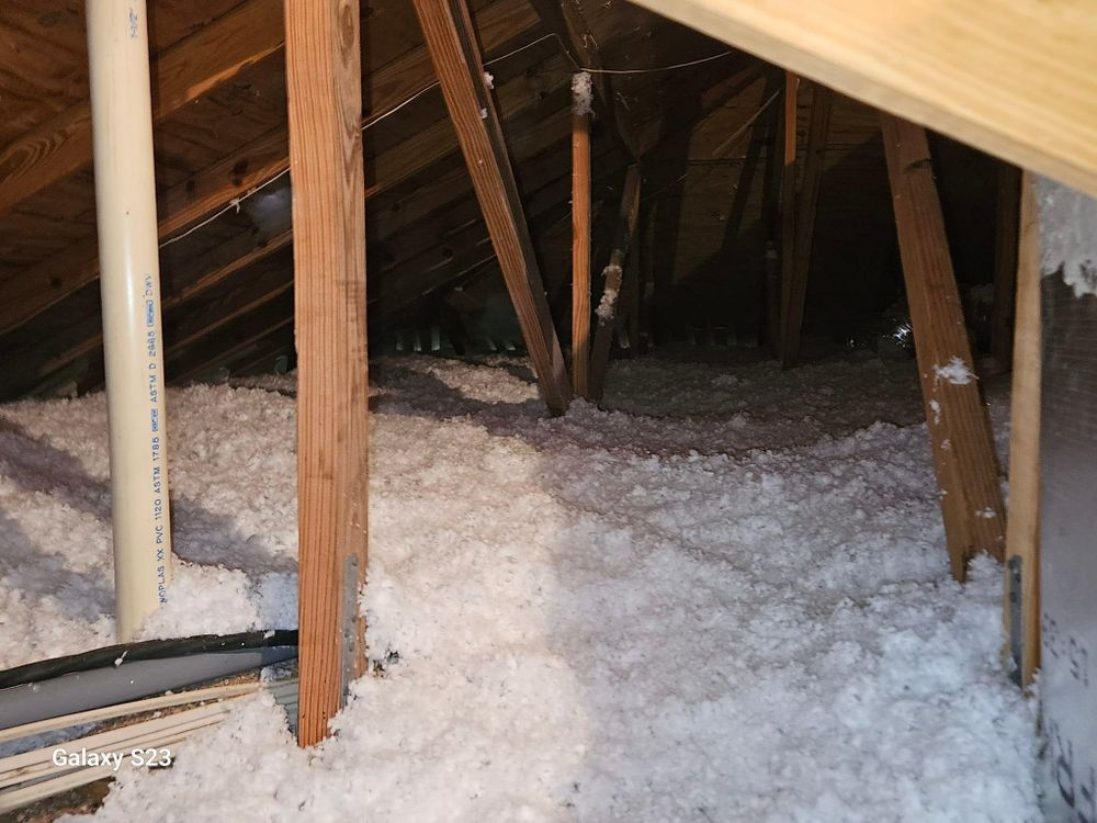 There is a lot of insulation in the attic of a house.