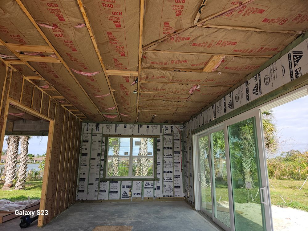 A room with a lot of windows and insulation on the ceiling.
