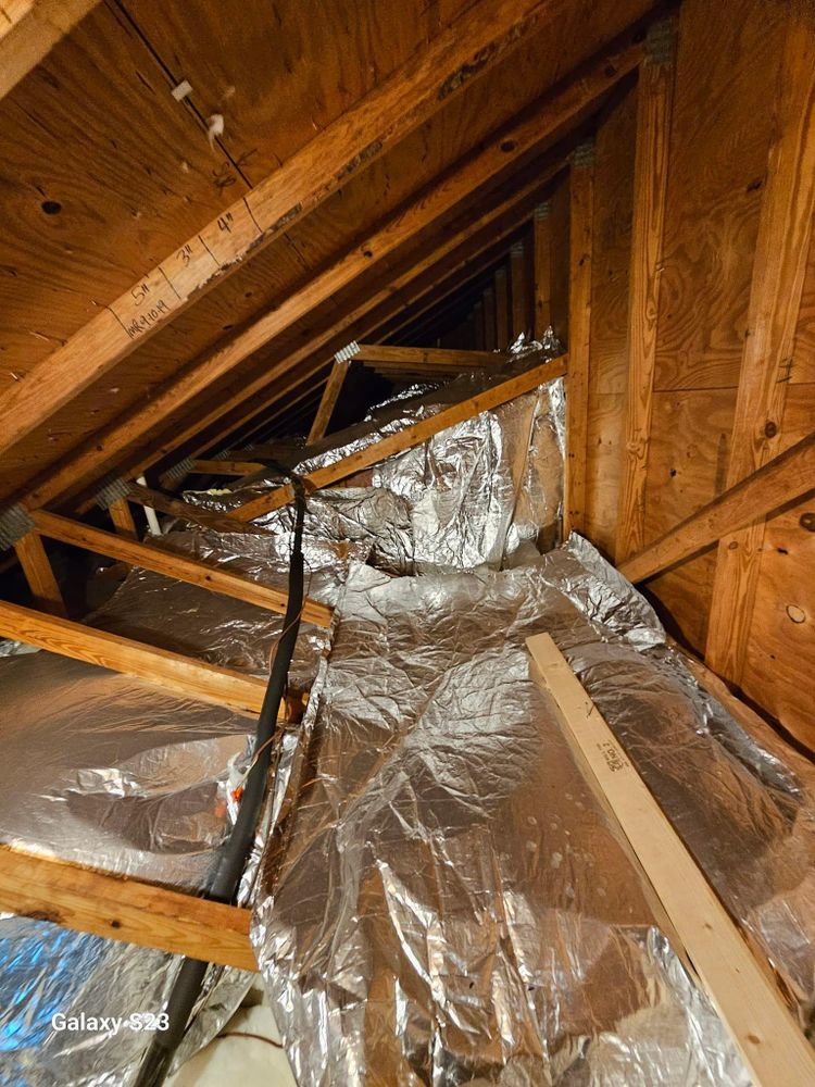 There is a lot of aluminum foil in the attic of a house.