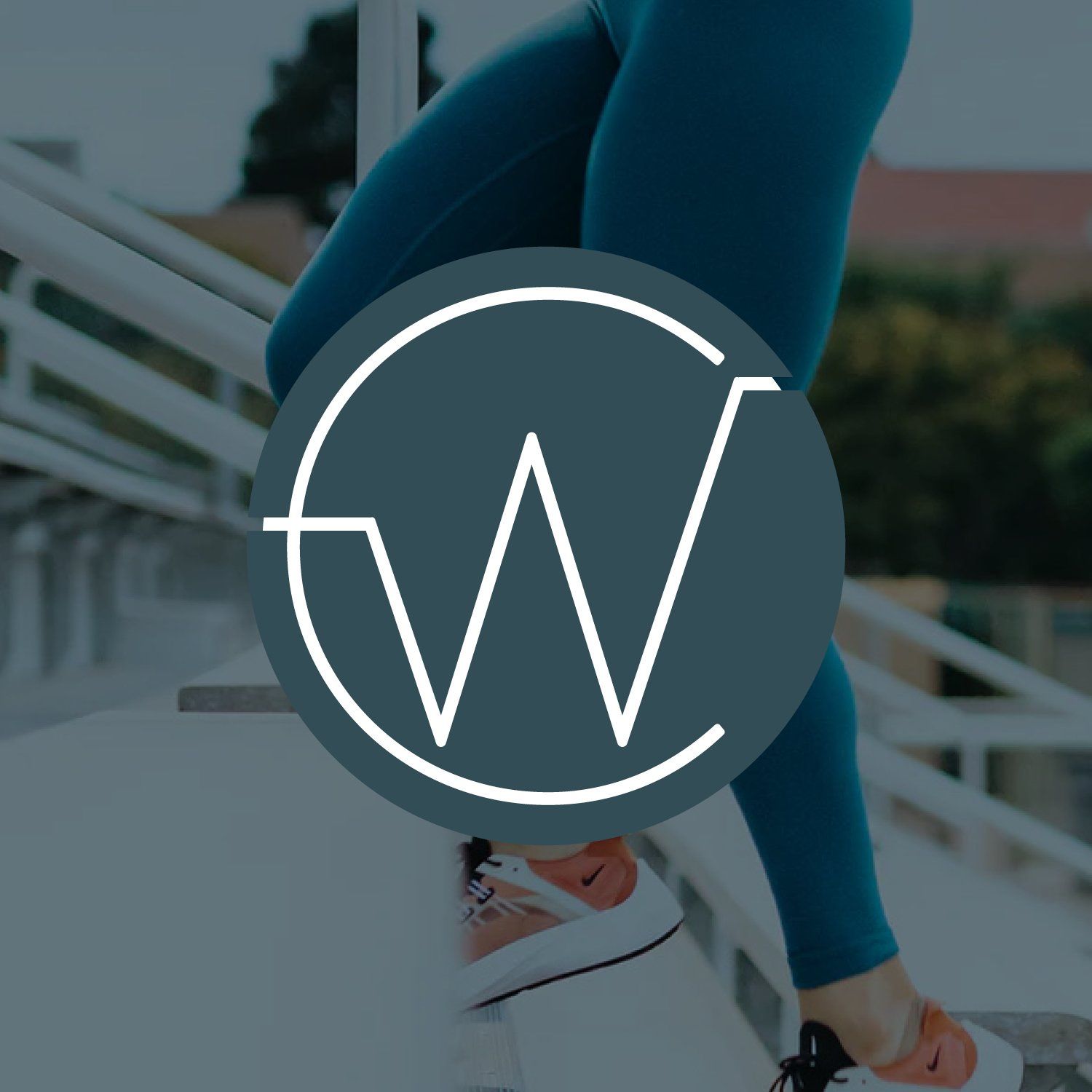A person is standing on a set of stairs with the letter w in the circle