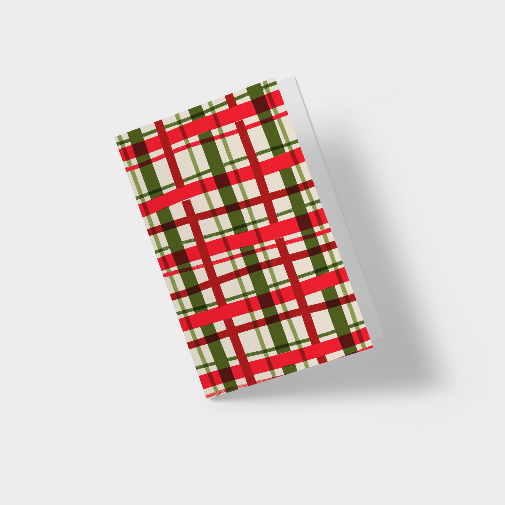 A christmas card with a red , green and white plaid pattern