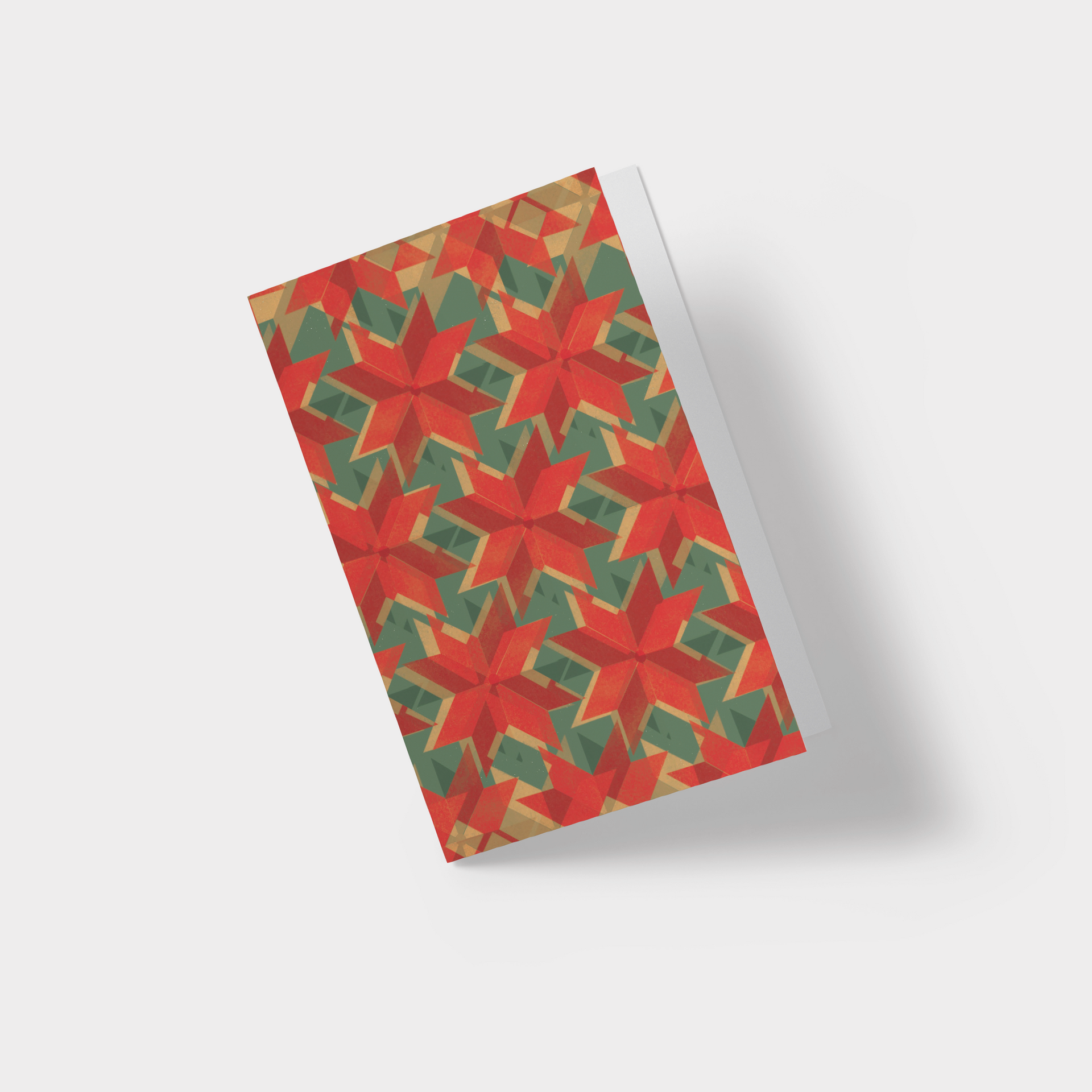 A greeting card with a red and green geometric pattern on it
