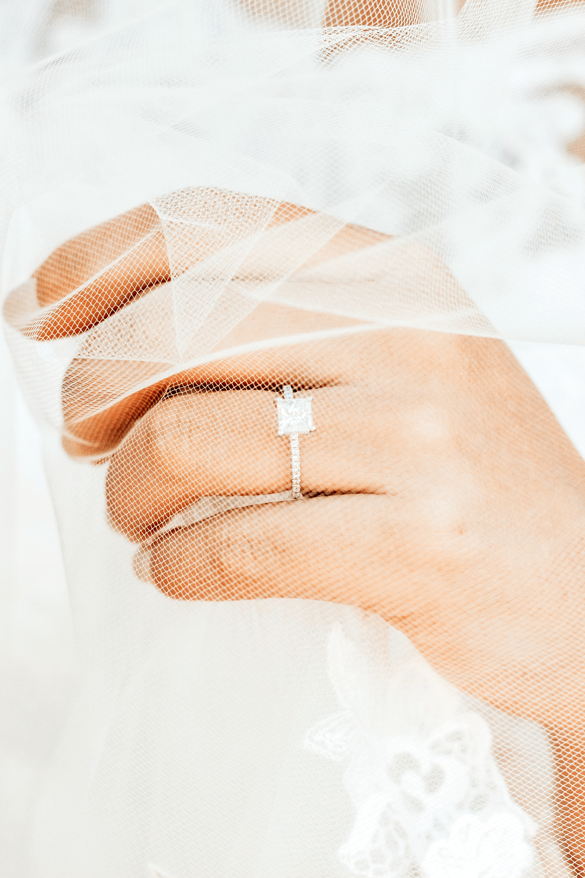 A woman is wearing a wedding ring on her finger.