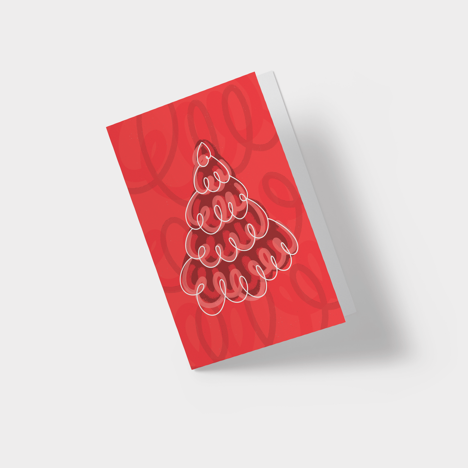 A red christmas card with a christmas tree made of spirals