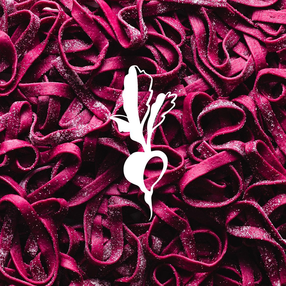 A bunch of purple noodles with a white flower in the middle