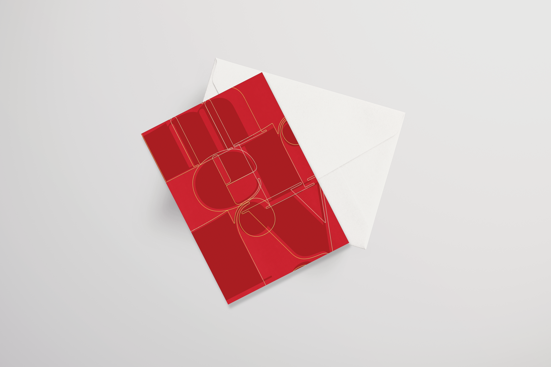 A red and white greeting card is sitting on top of a white envelope.