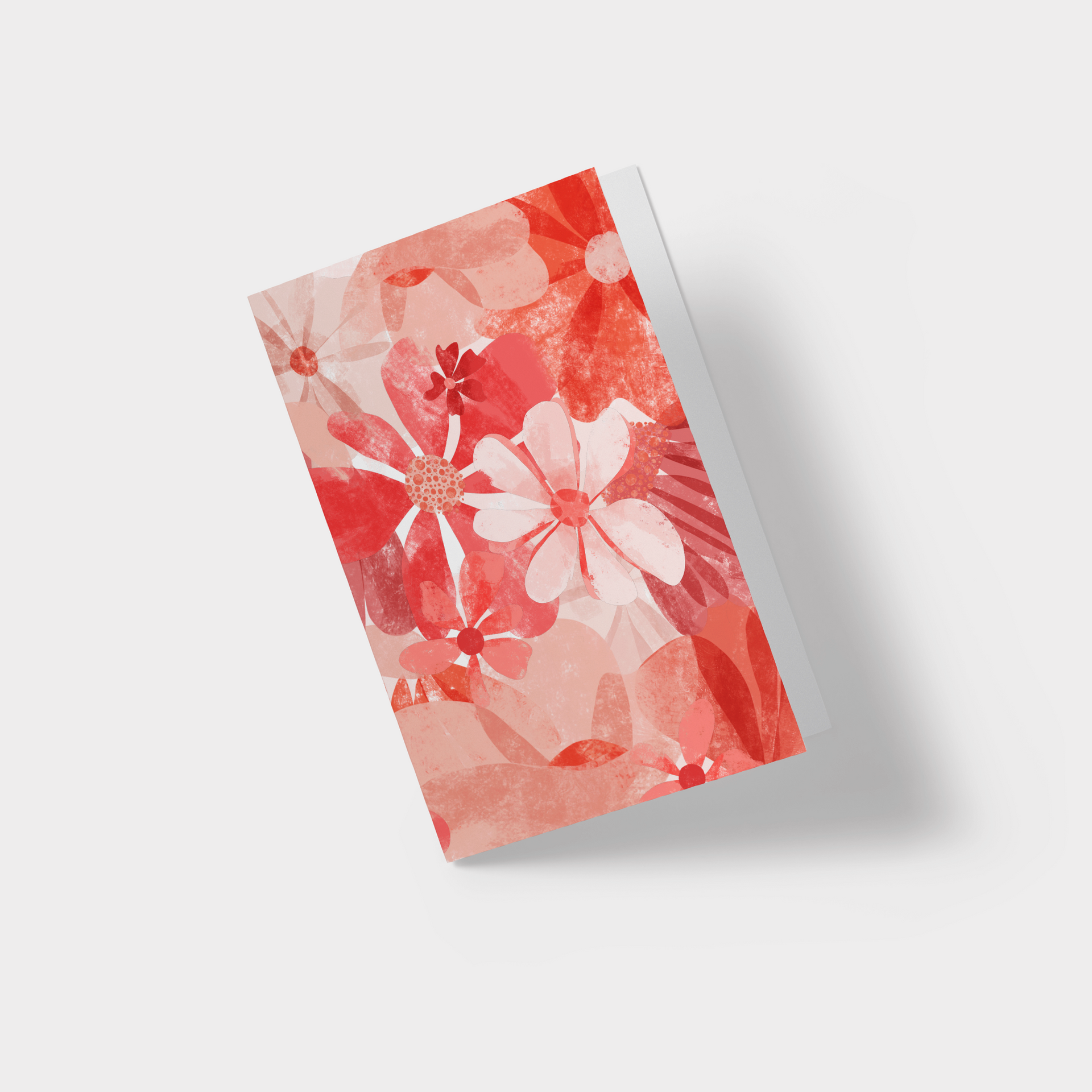A greeting card with red flowers on it