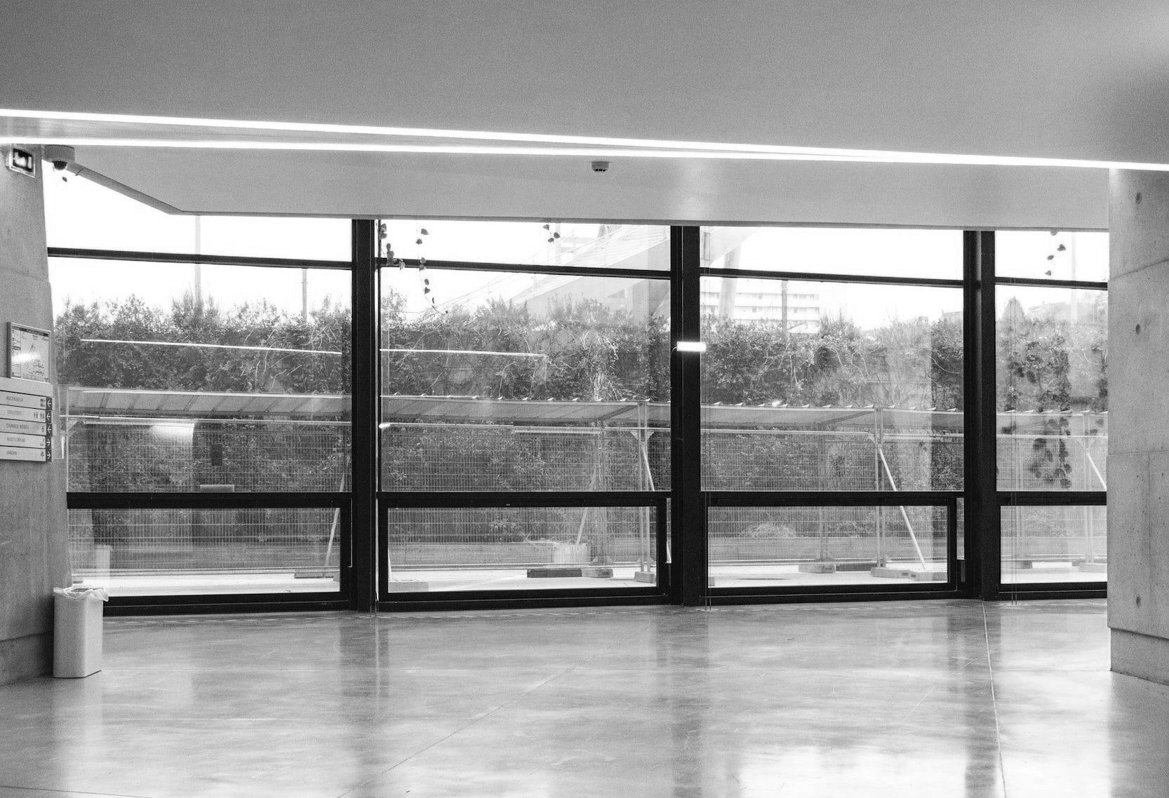 A black and white photo of a building with a lot of windows