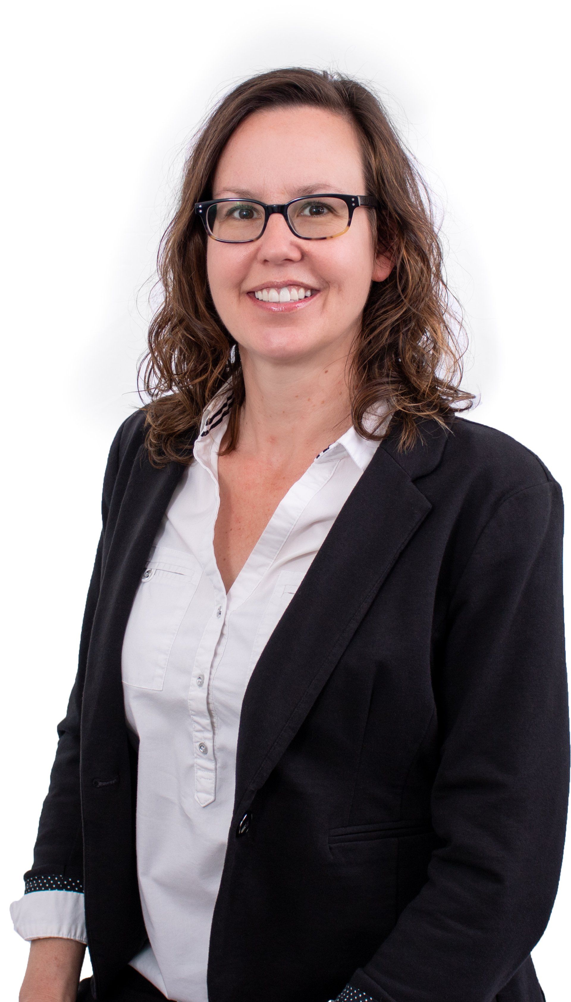 Woman in glasses, blazer and white shirt smiling.