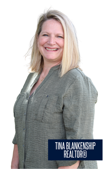 Woman in black blazer and blue top smiling, with a nameplate reading “Tina Blankenship Realtor”