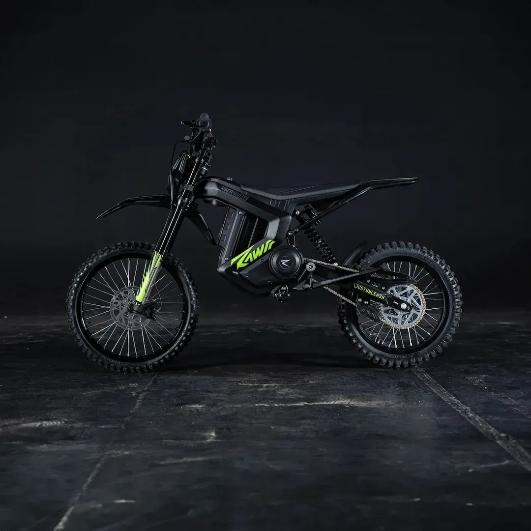 Black dirt bike with neon green accents on a dark studio background