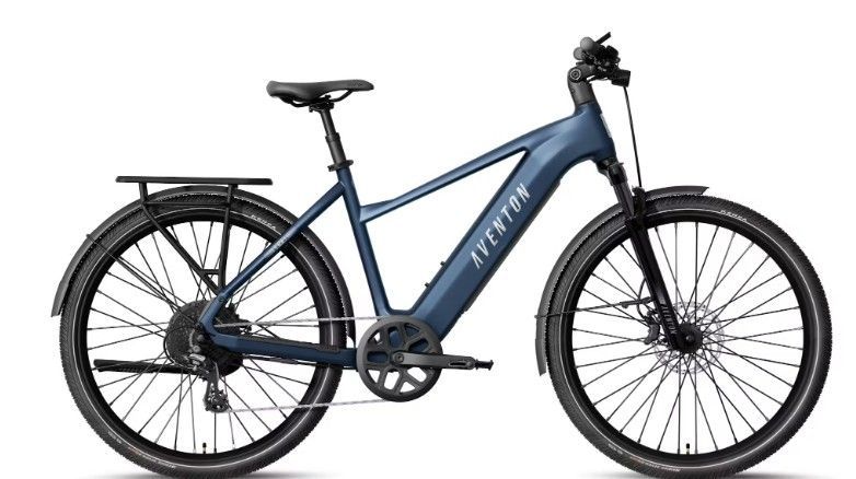 Blue electric bicycle with rear rack and front suspension, shown in side view on a white background