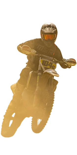 Dirt biker midair against a bright, dusty background