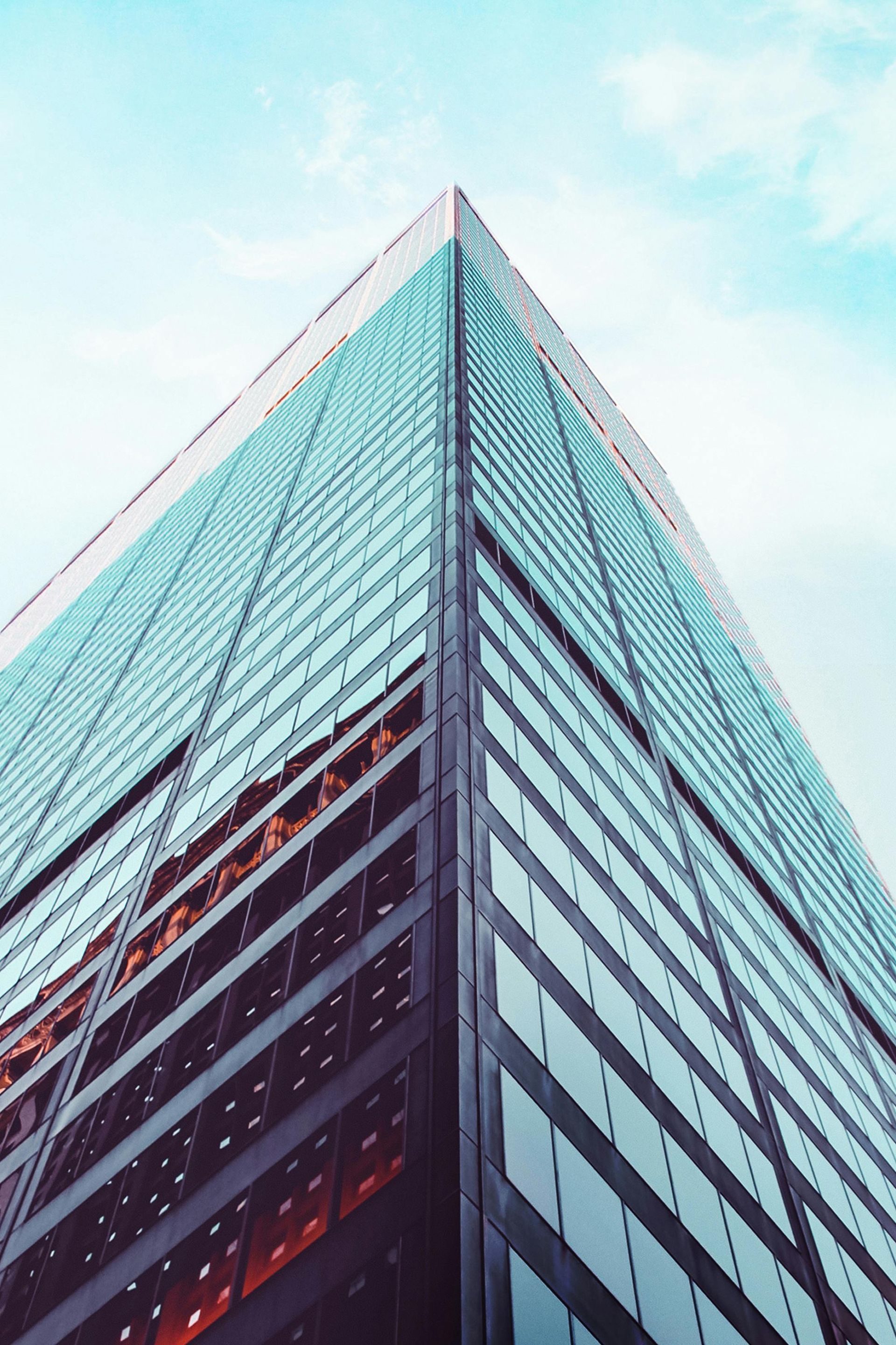 Looking up at a tall building with a blue sky in the background.