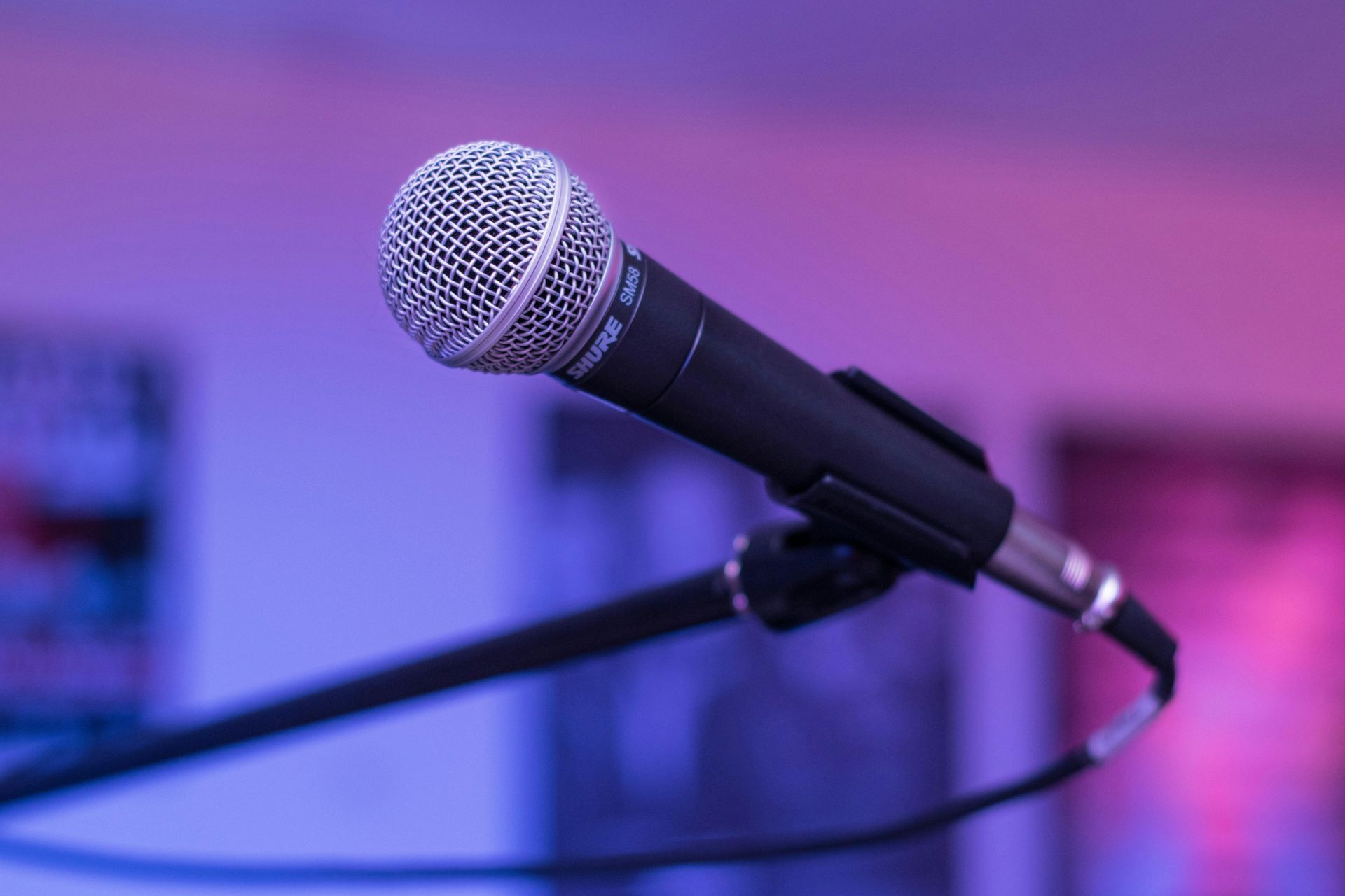 Vocal microphone on stage representing the origins of copywriting and audience resonance for Mark Mandelbaum.