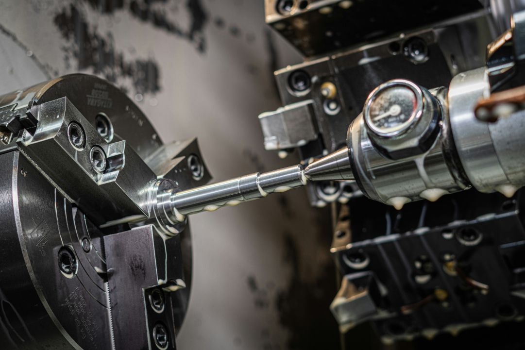 A machine is cutting a piece of metal on a machine.