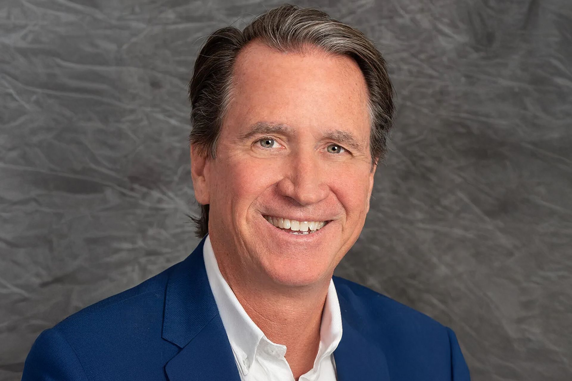 A photo of Jim Neubauer smiling for the camera.