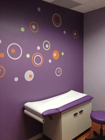 A purple wall with circles painted on it at Advocare Washington Ave Pediatrics in Bergenfield, NJ