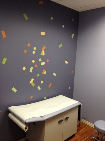 A doctor 's office with a table and a stool at Advocare Washington Ave Pediatrics in Bergenfield, NJ