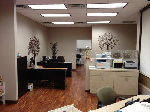 Wooden floors and a tree on the wall at Advocare Washington Ave Pediatrics in Bergenfield, NJ
