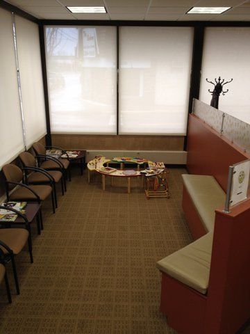 A waiting room with chairs , tables and a bench at Advocare Washington Ave Pediatrics in Bergenfield, NJ