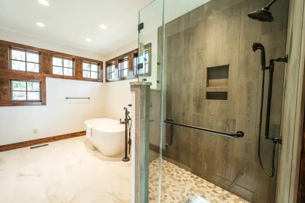 A bathroom with a tub and a walk in shower.