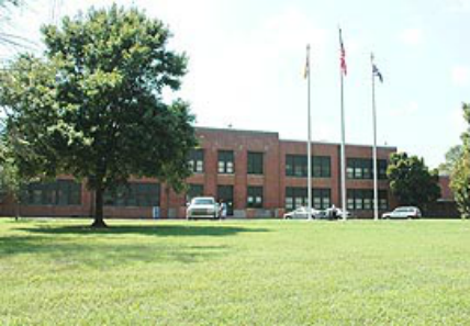 A large brick building with a tree in front of it