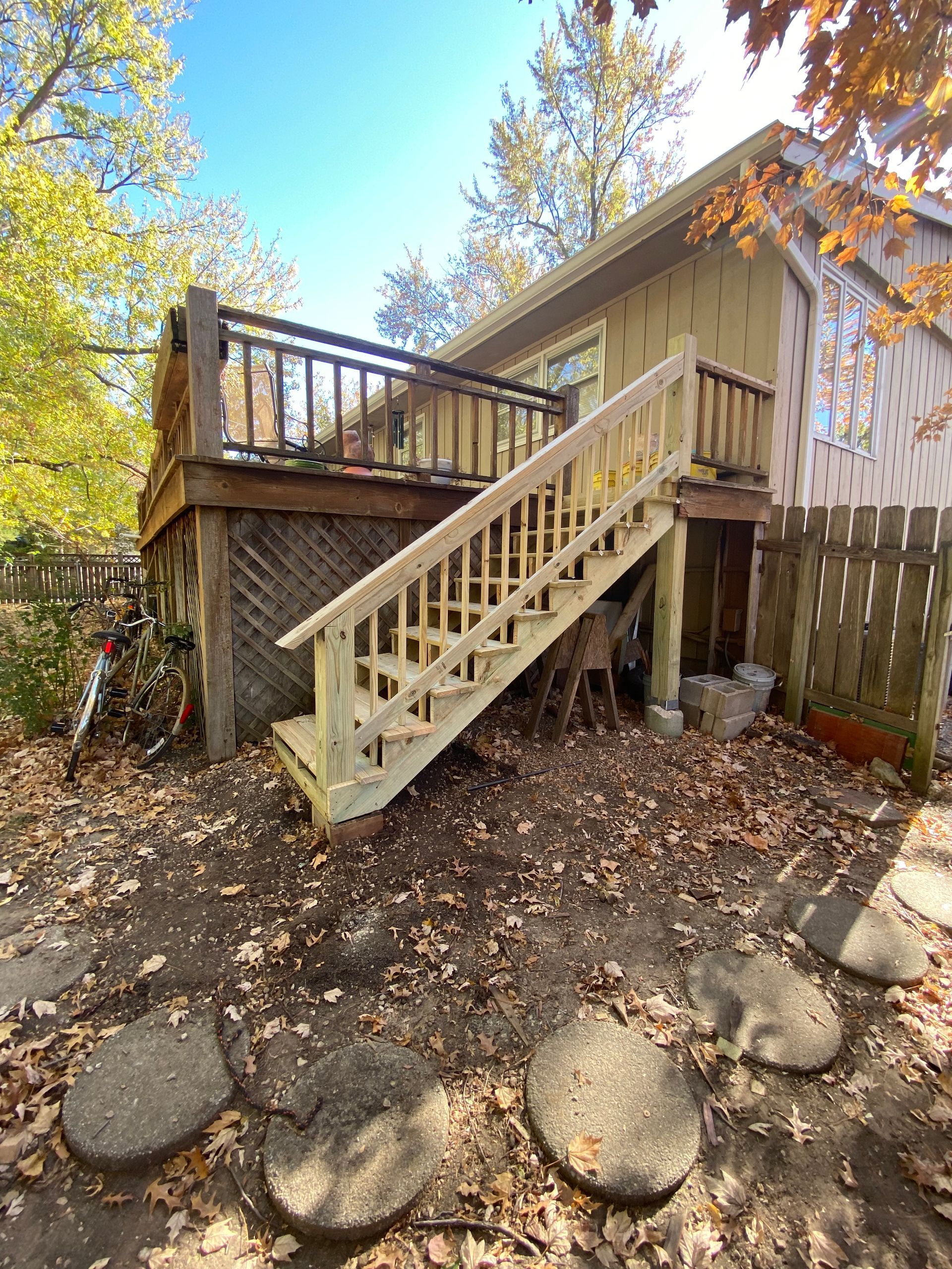A house with a deck and stairs leading up to it.