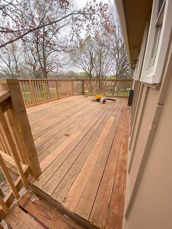 A wooden deck is being built on the side of a house.