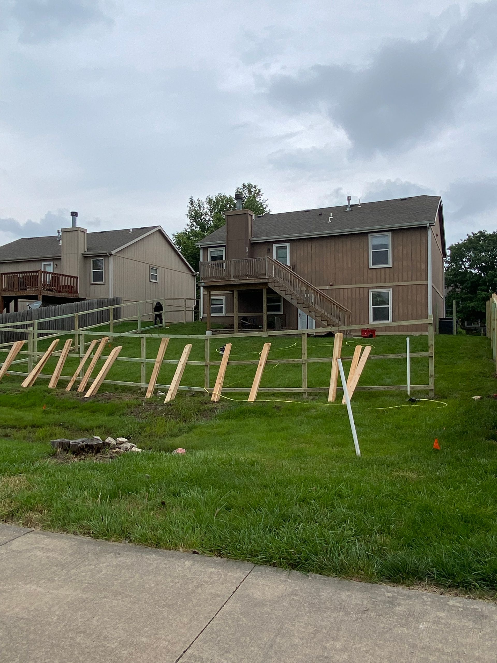 A house with a wooden fence in front of it
