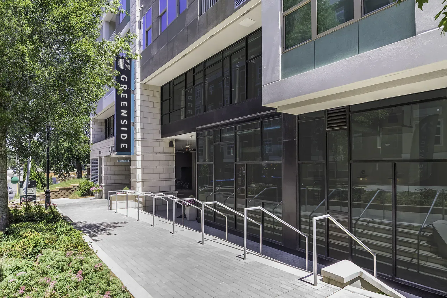 Exterior view of GreenSide building with a sidewalk, ramp and sign.