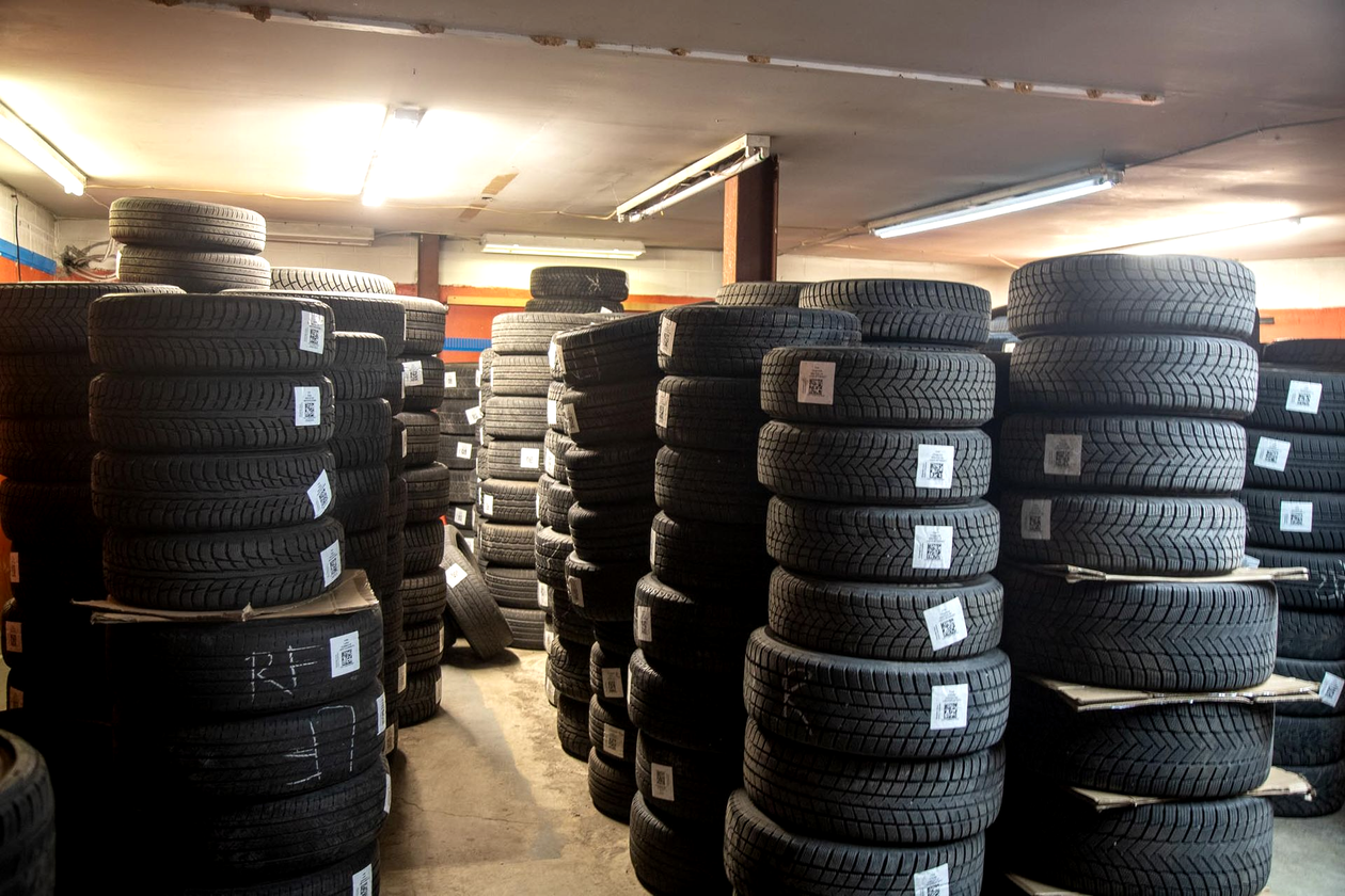 Stack of black car tires in an auto shop garage