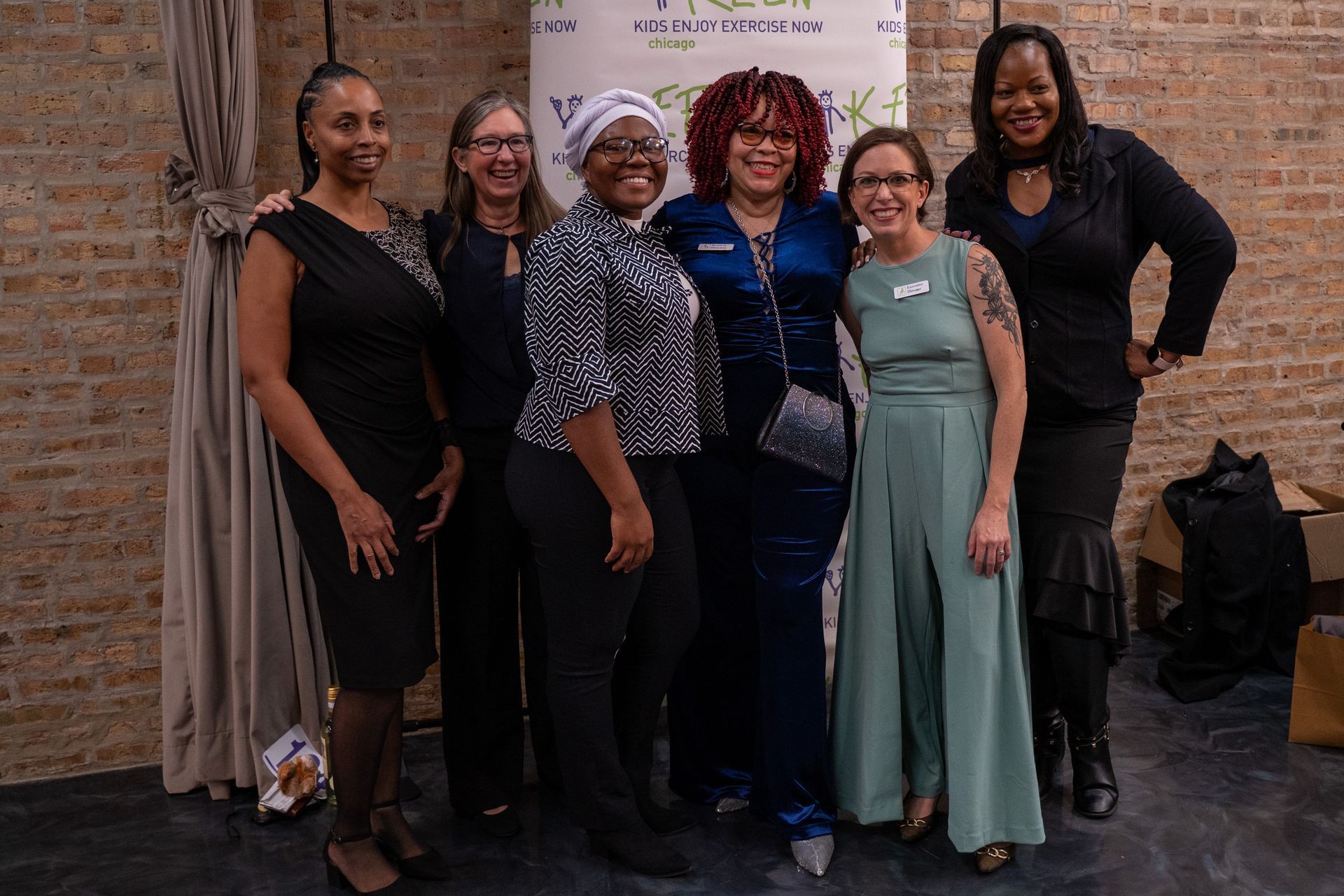 Here a KEEN Parent, KEEN Chicago's Executive Director, and 4 program partners pose together for a photo.