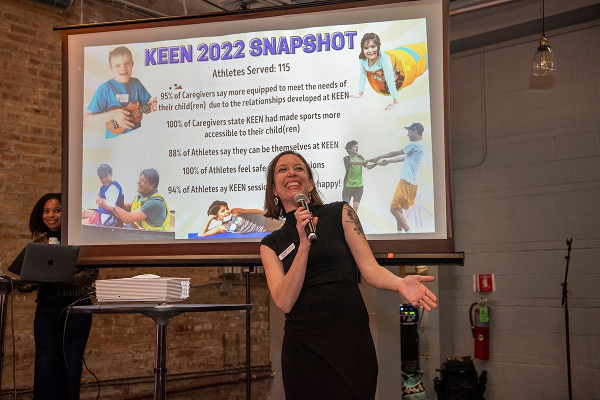 Laura Fillenwarth smiling speaking to attendees