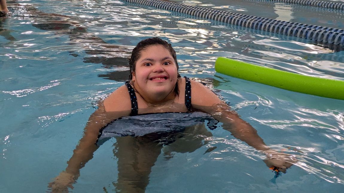 A KEEN Athlete smiles in the pool