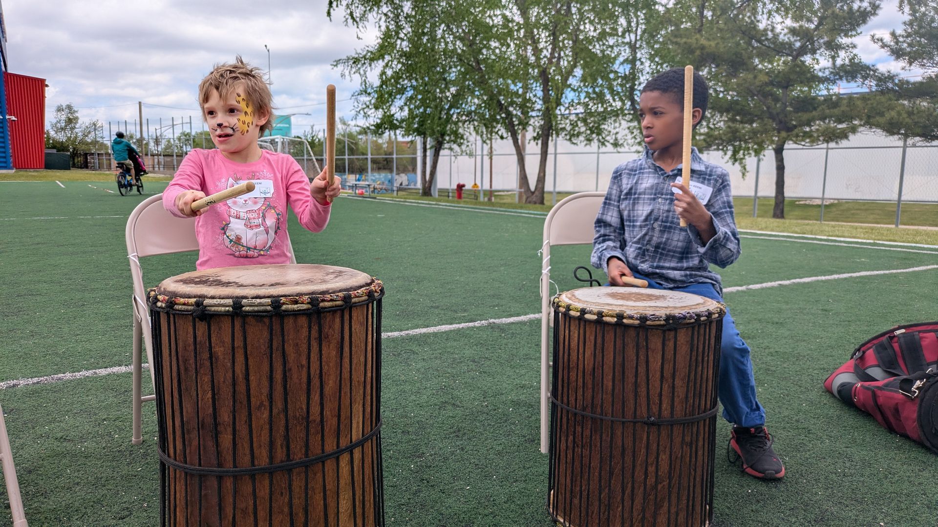 Two KEEN athletes play African drums together