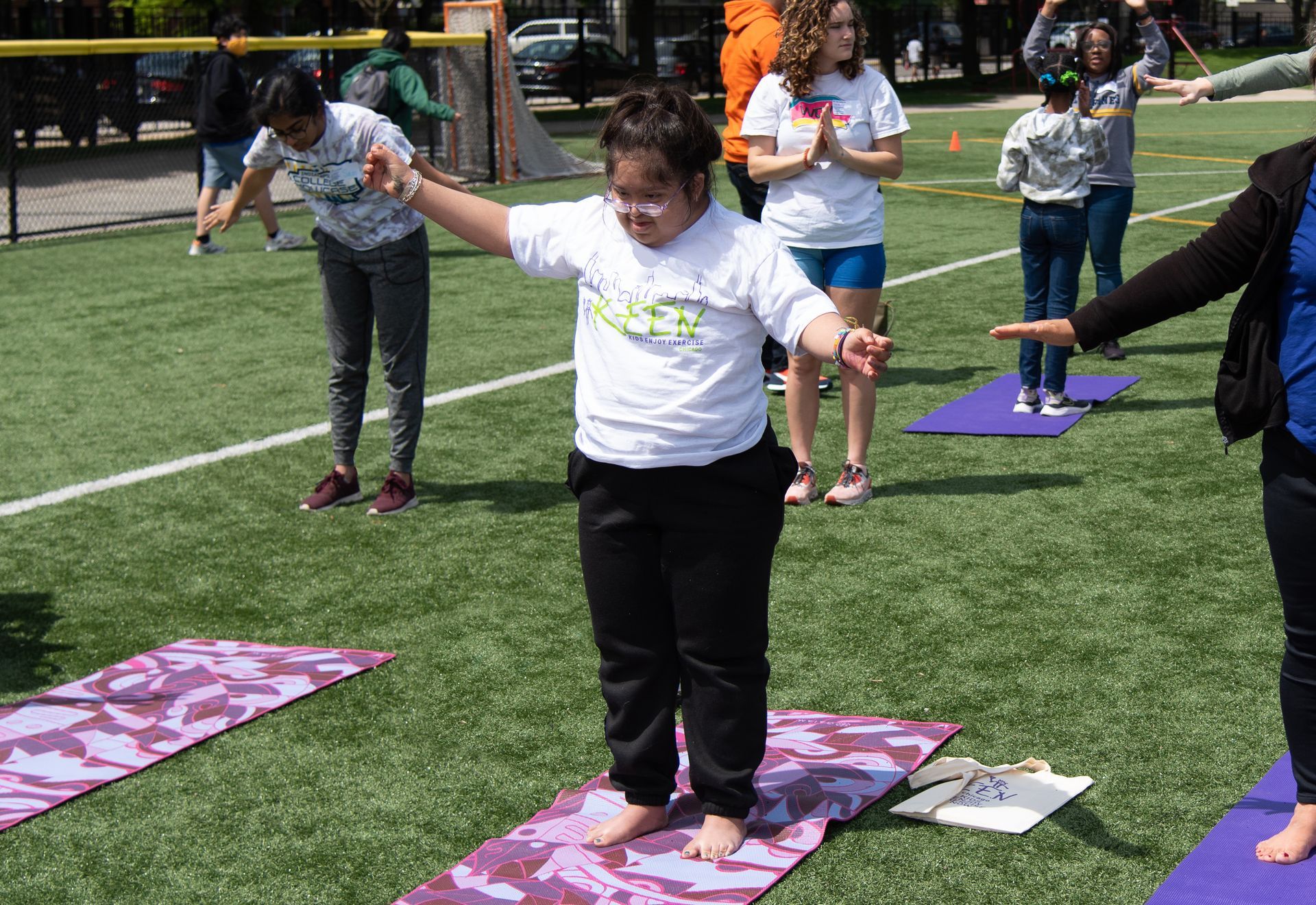 Athletes doing yoga in grass field