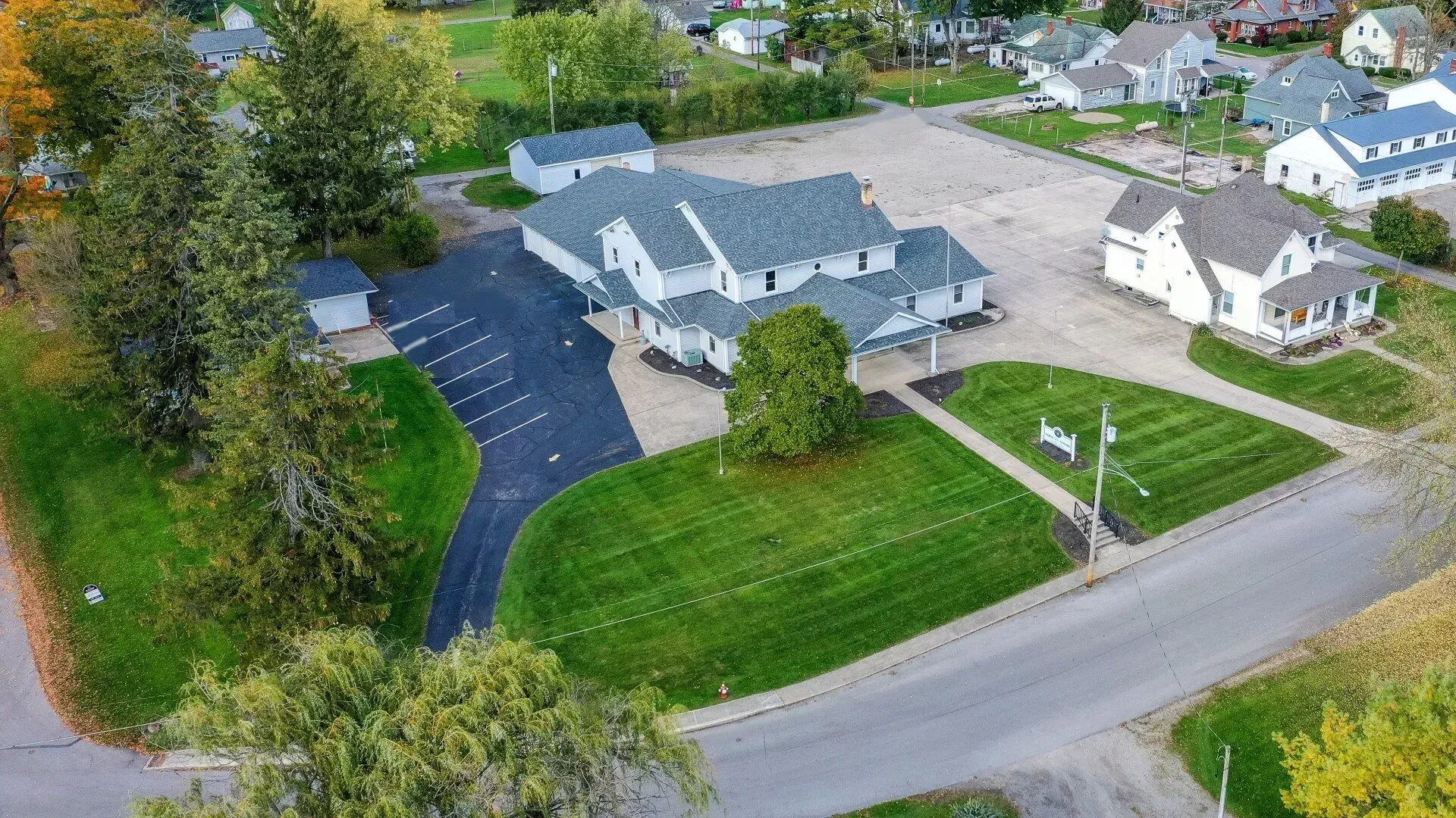 An aerial view of a residential area with houses and a parking lot.