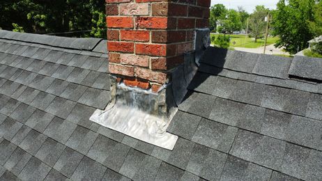 Chimney with angled roofline and green bricks.