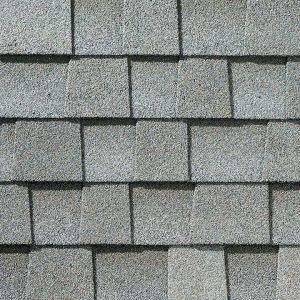 Gray asphalt roof shingles in a repeating pattern.