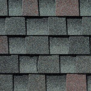 Close-up of asphalt roof shingles in shades of gray and brown.