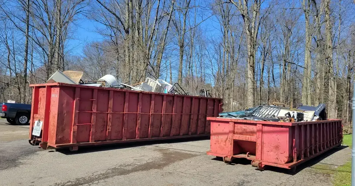 Two red NEO Junk Removal dumpsters loaded with items in Boardman, OH