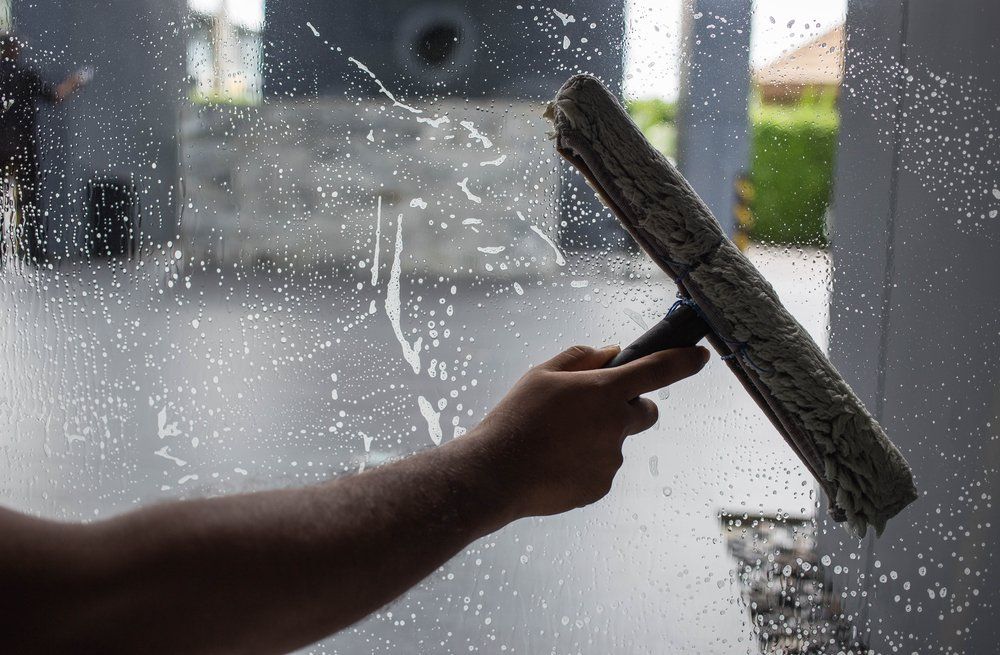 Man Holding a Window Wiper Cleaner — Highlands Window Cleaning in Mittagong, NSW