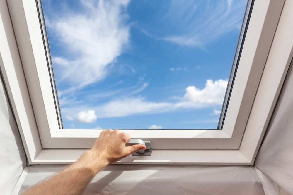 Man Closing the Skylight — Highlands Window Cleaning in Mittagong, NSW