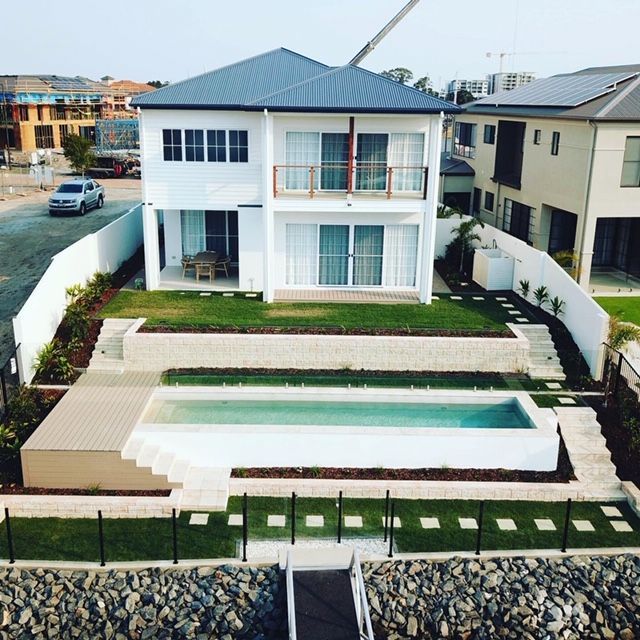 An aerial view of a house with a swimming pool