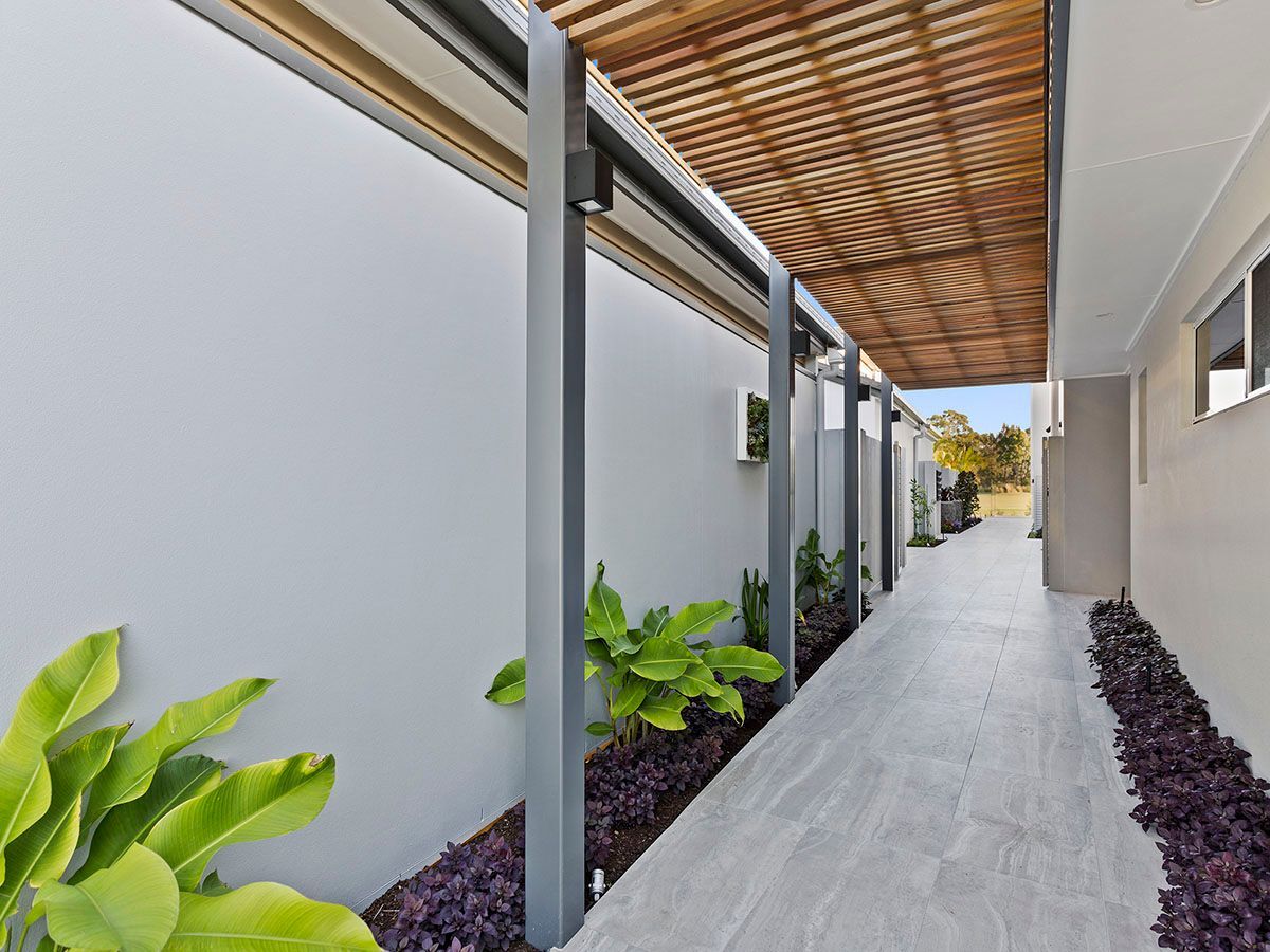 A walkway between two buildings with a wooden roof