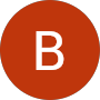A dark brown circle with a large white letter