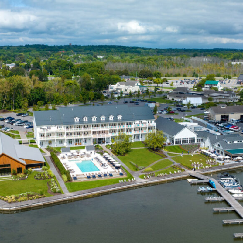 An aerial view of a large building next to a body of water